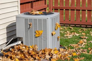 ac-condenser-outside-covered-in-leaves